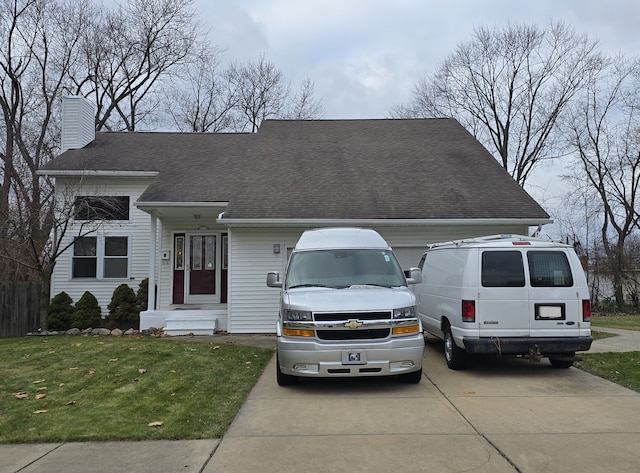 view of front of house with a garage and a front lawn