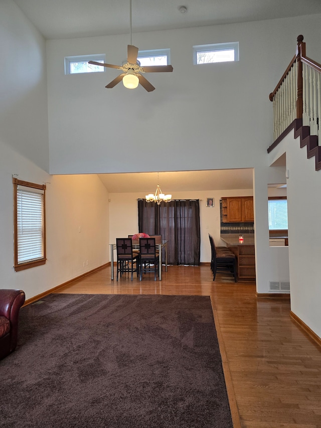 living room with a high ceiling and plenty of natural light