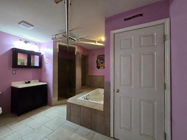 bathroom with plus walk in shower, tile patterned flooring, and vanity