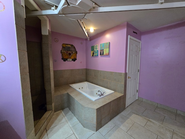 bathroom featuring tiled bath and tile patterned floors