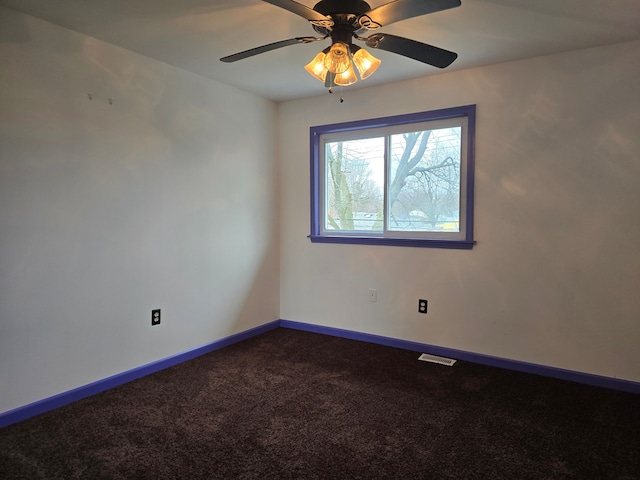 carpeted spare room with ceiling fan