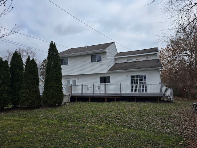 rear view of house with a yard and a wooden deck