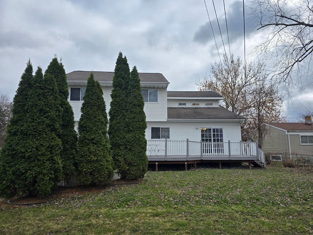 back of house featuring a yard and a wooden deck