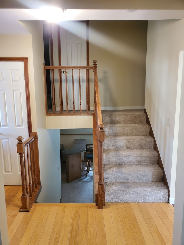 staircase with wood-type flooring