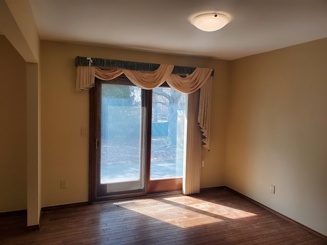 empty room featuring hardwood / wood-style floors and a healthy amount of sunlight