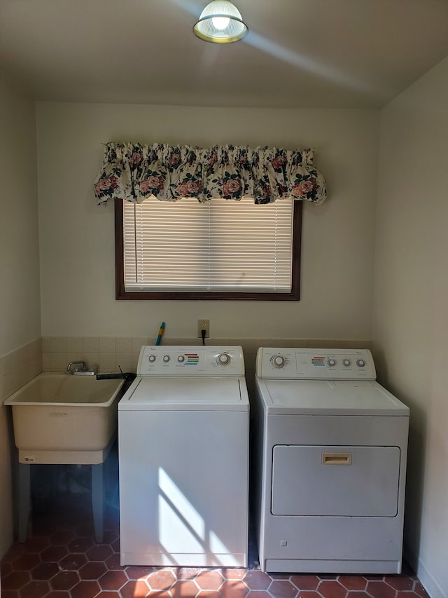 washroom featuring washing machine and dryer, tile patterned floors, and sink