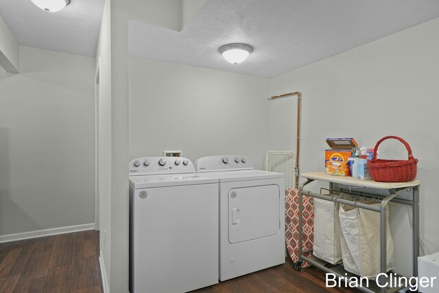 laundry area with a textured ceiling, independent washer and dryer, and dark wood-type flooring