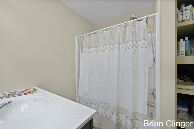 bathroom with shower / bath combination with curtain and vanity