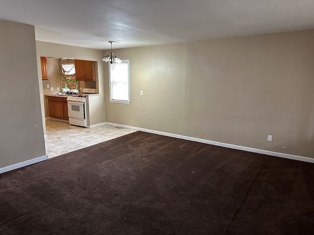 interior space with light carpet, white range, sink, decorative light fixtures, and an inviting chandelier