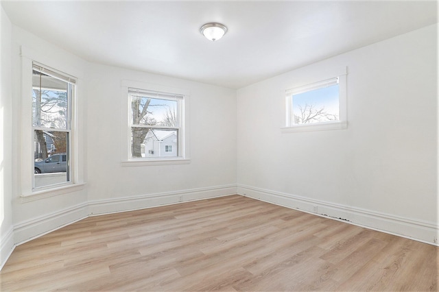 empty room featuring light hardwood / wood-style flooring and plenty of natural light