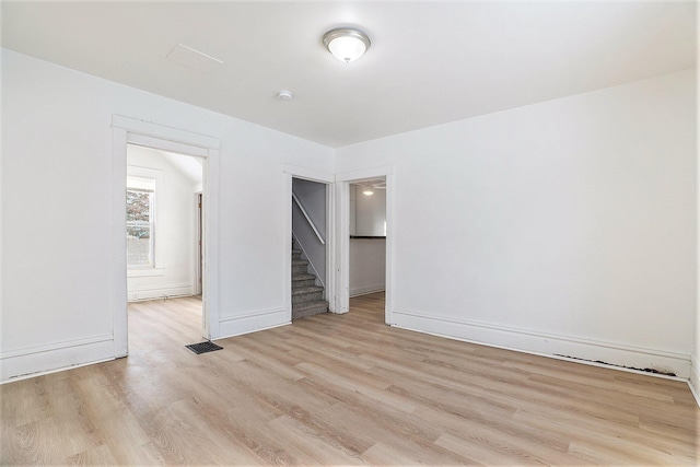 empty room with light hardwood / wood-style flooring