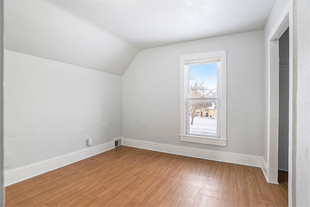 bonus room featuring hardwood / wood-style floors and lofted ceiling