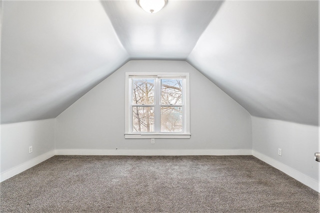 bonus room with carpet flooring and vaulted ceiling