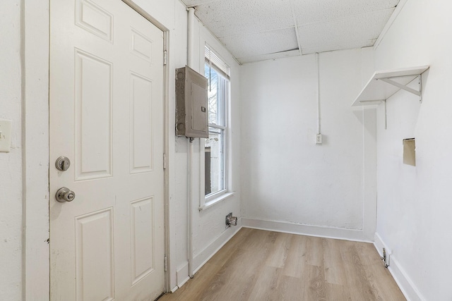 washroom featuring electric panel and light hardwood / wood-style floors