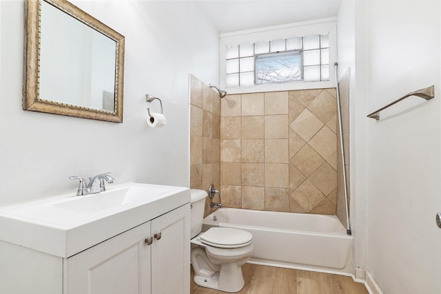 full bathroom with vanity, toilet, wood-type flooring, and tiled shower / bath