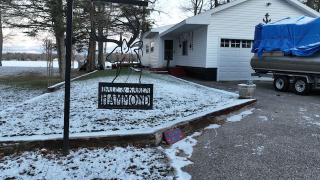 yard layered in snow with a garage