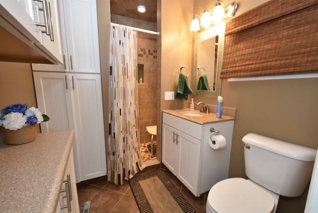 bathroom with vanity, a shower with curtain, tile patterned floors, and toilet