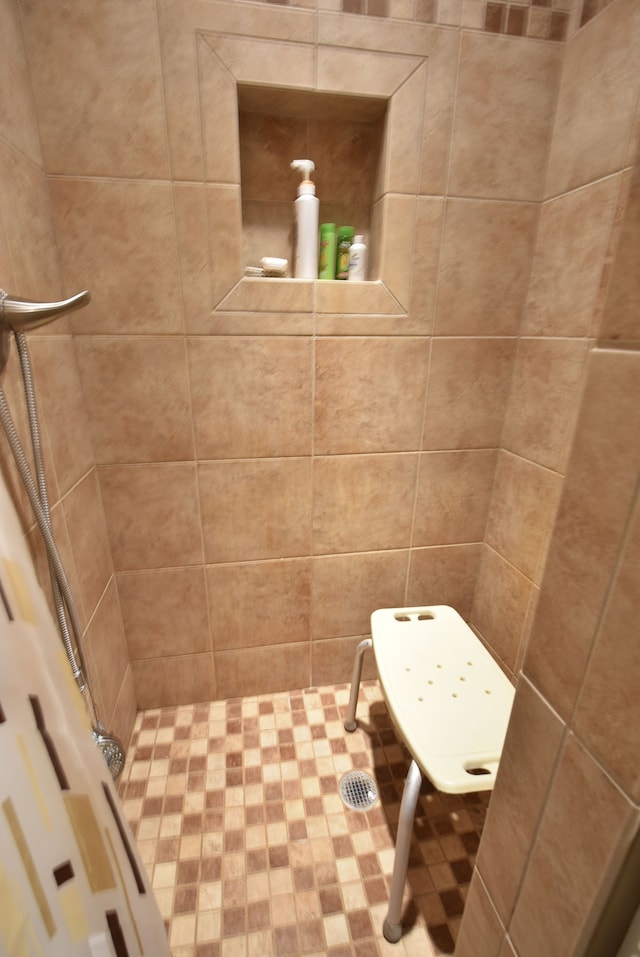 bathroom with a tile shower