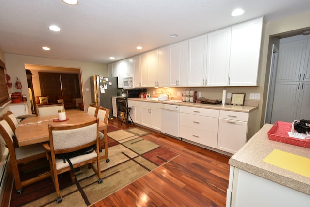 kitchen with white cabinetry, stainless steel appliances, dark hardwood / wood-style flooring, and sink