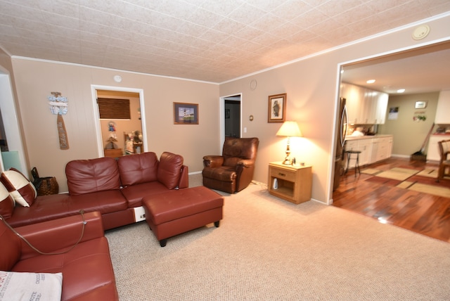 carpeted living room featuring ornamental molding