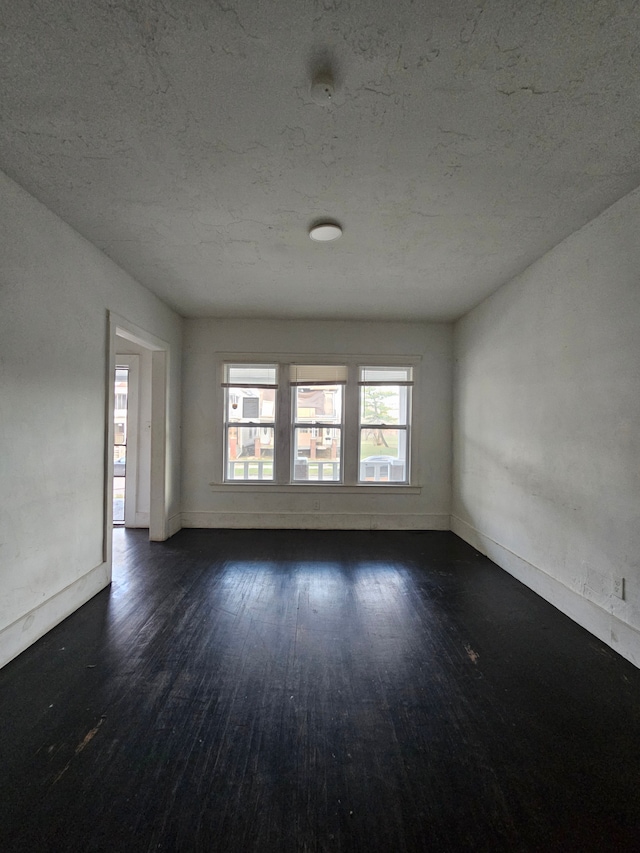 empty room featuring dark hardwood / wood-style floors