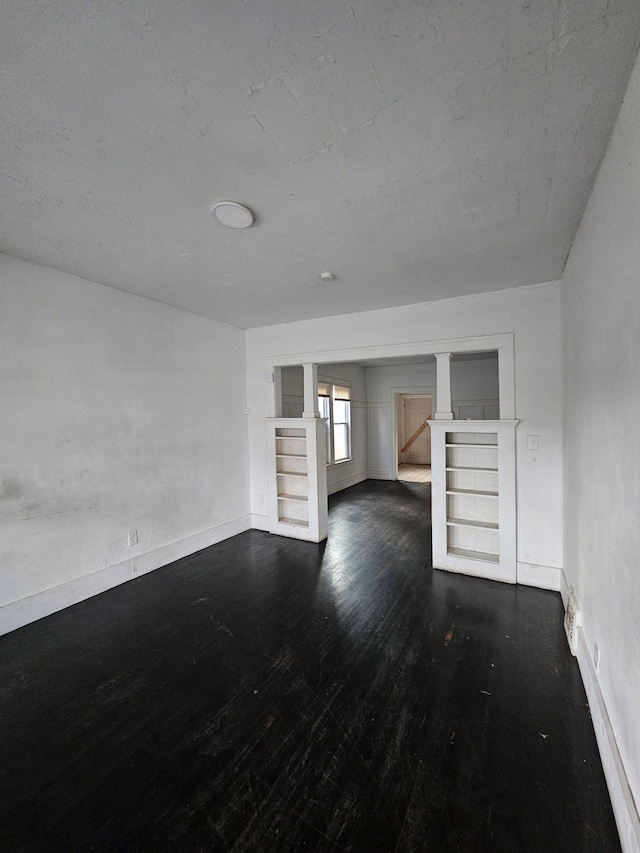 unfurnished living room featuring dark hardwood / wood-style flooring