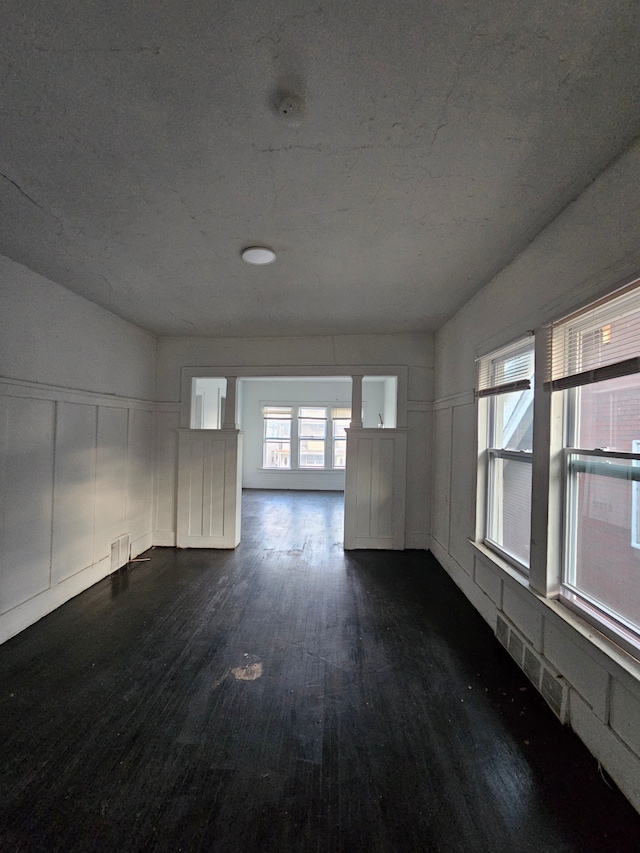 spare room with dark hardwood / wood-style flooring