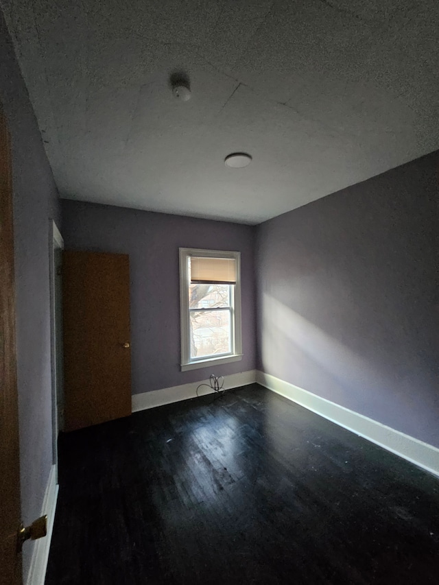 spare room featuring dark hardwood / wood-style floors