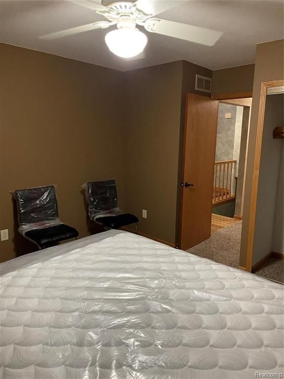 carpeted bedroom featuring ceiling fan