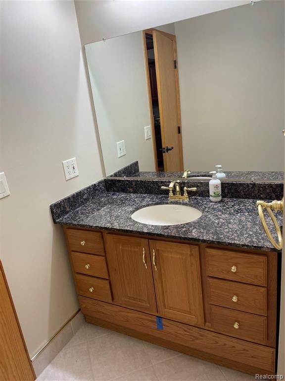 bathroom featuring tile patterned flooring and vanity