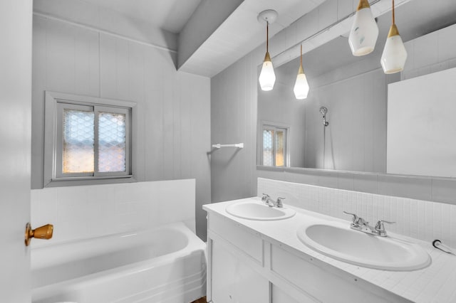 bathroom with tasteful backsplash, a bathtub, and vanity