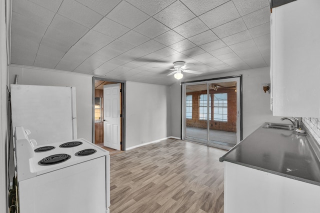 kitchen with white appliances, ceiling fan, sink, white cabinets, and light hardwood / wood-style floors