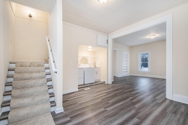 unfurnished living room featuring washing machine and dryer and dark wood-type flooring