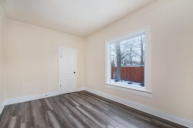 empty room featuring dark hardwood / wood-style flooring and ornamental molding