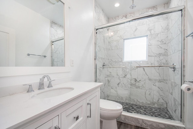 bathroom featuring hardwood / wood-style floors, vanity, toilet, and walk in shower