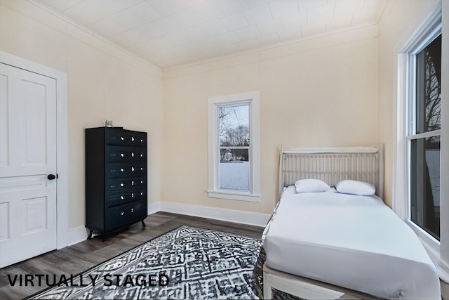 bedroom featuring dark hardwood / wood-style floors and ornamental molding