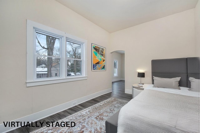 bedroom with dark wood-type flooring