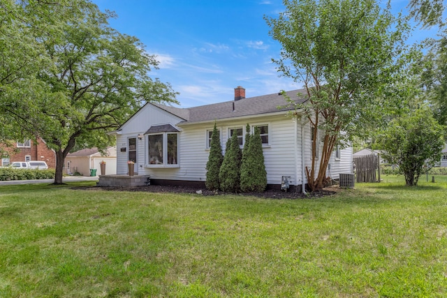 view of front of house featuring a front yard and central air condition unit