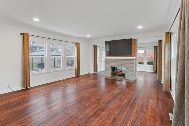 unfurnished living room featuring a fireplace, dark hardwood / wood-style floors, and ornamental molding