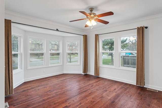 empty room featuring dark hardwood / wood-style floors, ceiling fan, and crown molding