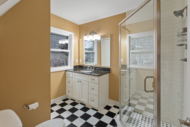 bathroom featuring vanity, toilet, and walk in shower