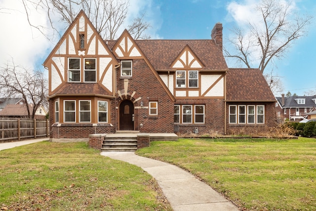 tudor-style house with a front yard