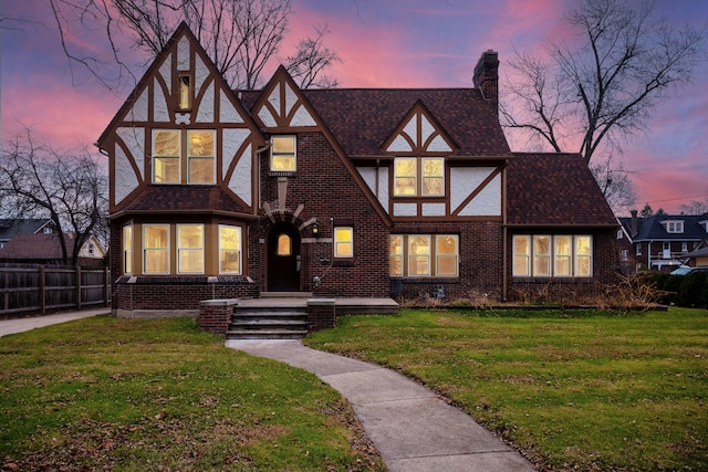 tudor home with a yard