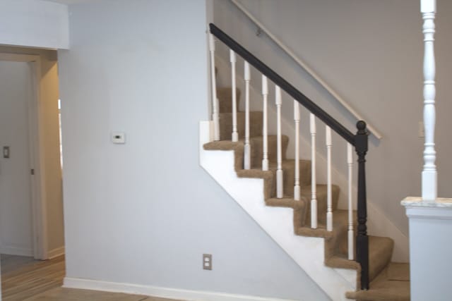 stairway featuring hardwood / wood-style floors