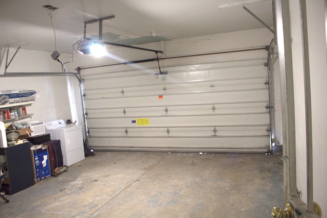 garage with a garage door opener and separate washer and dryer