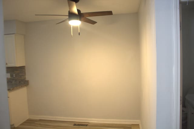 interior space with hardwood / wood-style floors and ceiling fan