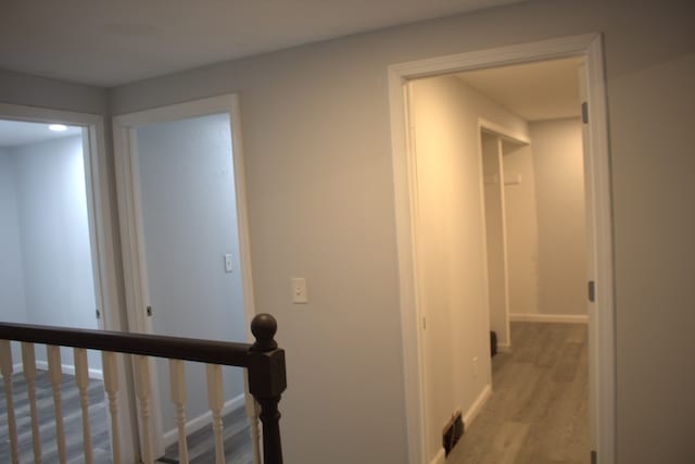 corridor with light hardwood / wood-style flooring