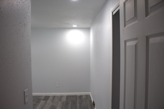 empty room featuring dark hardwood / wood-style flooring and a textured ceiling