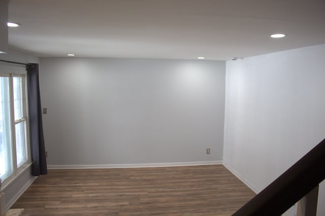 unfurnished room with dark hardwood / wood-style flooring