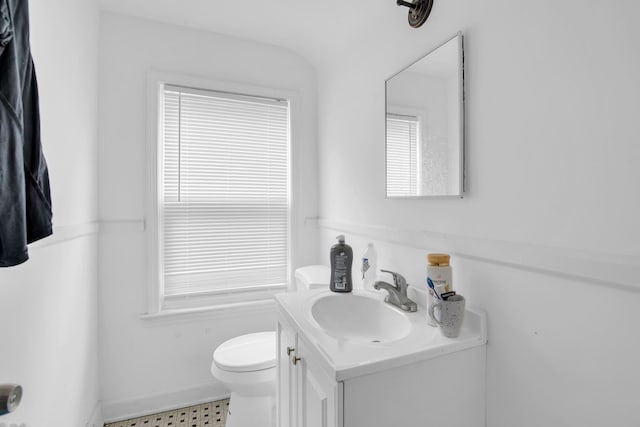 bathroom with vanity, toilet, and a wealth of natural light